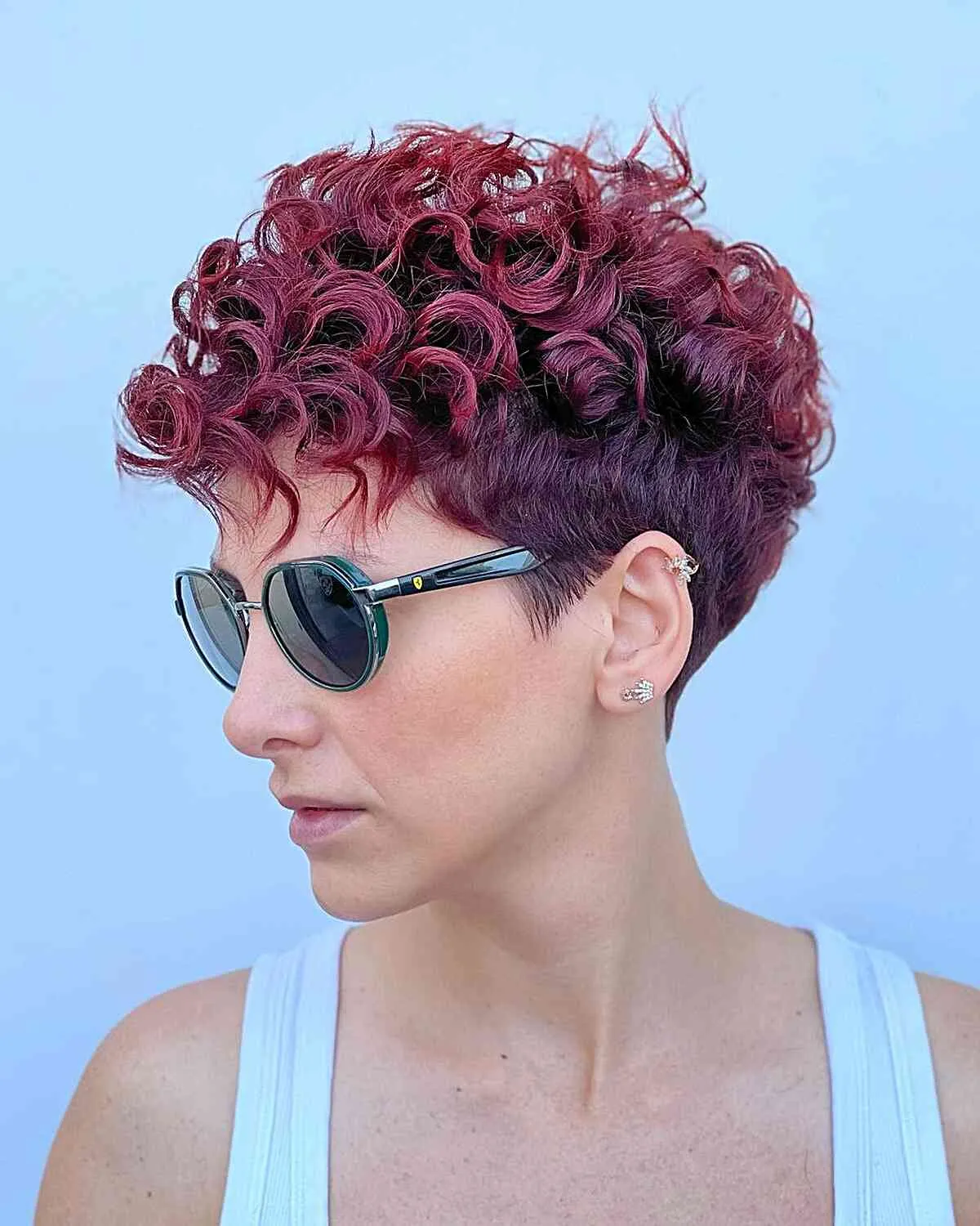 Stylish curly pixie with tapered edges and bangs