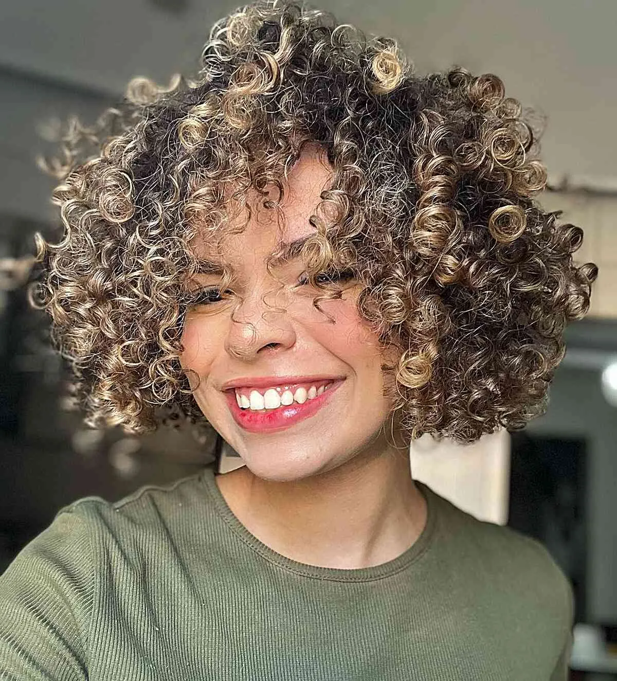 Short Frizzy Curls with Subtle Blonde Accents for girls with thick curly hair